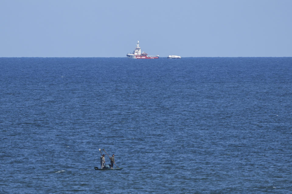 A ship belonging to the Open Arms aid group approaches the shores of Gaza towing a barge with 200 tons of humanitarian aid on Friday, March 15, 2024. The ship set sail Tuesday from Cyprus to inaugurate a sea route to get desperately needed aid into the war-wracked enclave, which is suffering a humanitarian crisis five months into the Israel-Hamas war. (AP Photo/Abdel Kareem Hana)