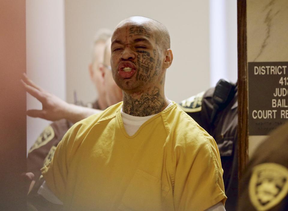 Nikko Jenkins, charged with four counts of first-degree murder in the slayings of four Omaha people last summer, is led from court by Douglas County deputies in Omaha, Neb., Wednesday, April 16, 2014. Jenkins was found guilty on all charges. (AP Photo/Nati Harnik)