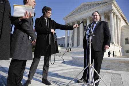 Rabbi Binyomin Ginsberg (R) talks to reporters about his case, in which he sued Northwest Airlines for breach of contract after the airline said he had abused their frequent flyer program, following arguments before the U.S. Supreme Court in Washington December 3, 2013. REUTERS/Jonathan Ernst