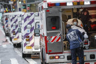 FILE - In this April 13, 2020, file photo, a patient arrives in an ambulance cared for by medical workers wearing personal protective equipment due to COVID-19 concerns outside NYU Langone Medical Center in New York. As coronavirus rages out of control in other parts of the U.S., New York is offering an example after taming the nation’s deadliest outbreak this spring — but also trying to prepare in case another surge comes. (AP Photo/John Minchillo, File)