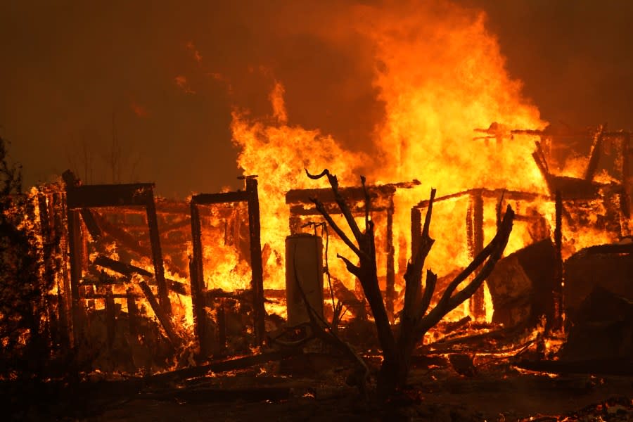 A home burns along Cima Mesa Rd. as the Bobcat Fire advances Friday, Sept. 18, 2020, in Juniper Hills, Calif. (AP Photo/Marcio Jose Sanchez)