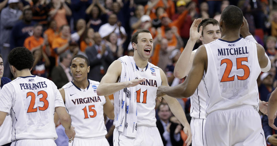 Virginia players celebrate at halftime in the first half of an NCAA college basketball third-round tournament game against Memphis, Sunday, March 23, 2014, in Raleigh. (AP Photo/Chuck Burton)