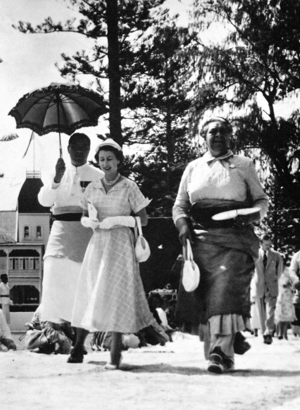 Tonga, 1953: Queen Elizabeth II and Queen Salote of Tonga leave a great open air feast given in honour of the Queen and the Duke of Edinburgh. (PA Archive/PA Images)