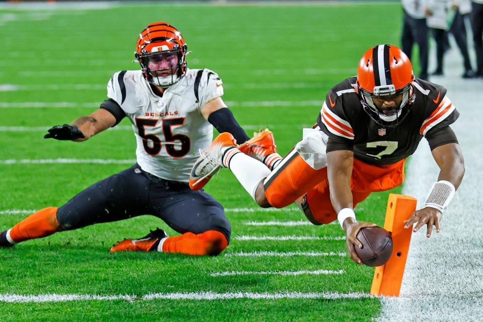 Browns quarterback Jacoby Brissett dives into the end zone for a second-half touchdown past Bengals linebacker Logan Wilson in Cleveland, Monday, Oct. 31, 2022.