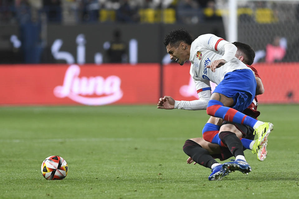 Barcelona's Raphinha fights for the ball with Osasuna player during the Spanish Super Cup semi final soccer match between Osasuna and Barcelona at Al Awal Park Stadium in Riyadh, Saudi Arabia, Thursday, Jan. 11, 2024. (AP Photo)