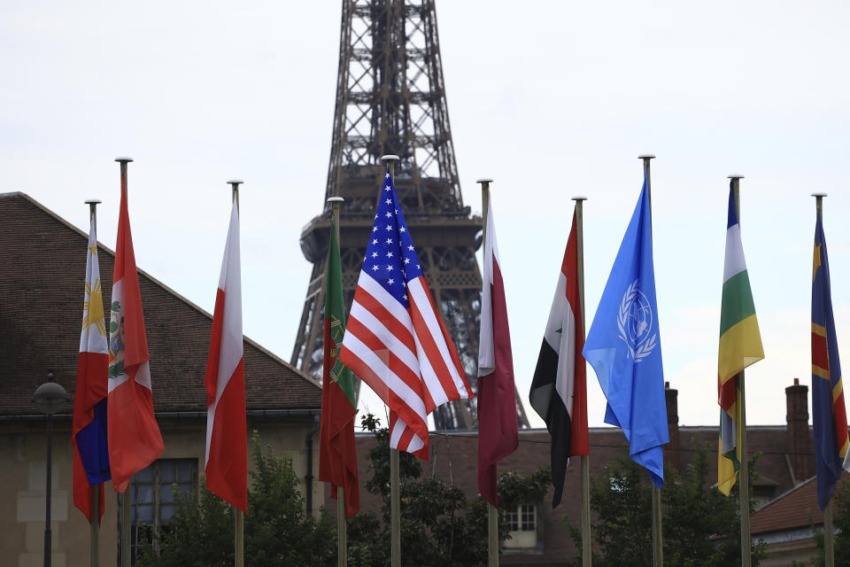 The U.S flag, center, flies during a ceremony at the UNESCO headquarters Tuesday, July 25, 2023 in Paris. U.S. first lady Jill Biden is in Paris on Tuesday to attend a flag-raising ceremony at UNESCO, marking Washington's official reentry into the U.N. agency after a five-year hiatus. (AP Photo/Aurelien Morissard, Pool)