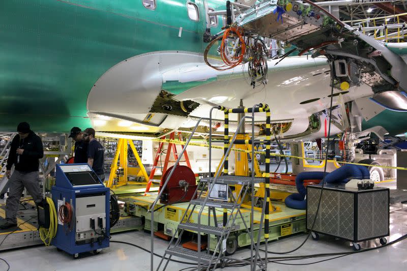 FILE PHOTO: Boeing employees work during a media tour of the Boeing 737 MAX at the Boeing plant in Renton, Washington