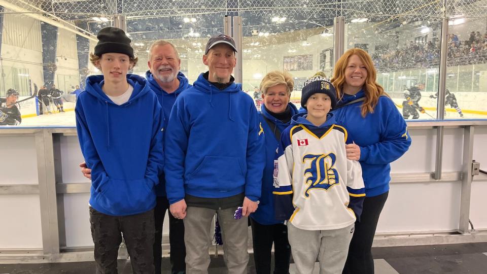 Eli with his parents, brother, and grandparents at the Brampton Hockey annual coaches vs coaches match, which was organized to honour his journey.