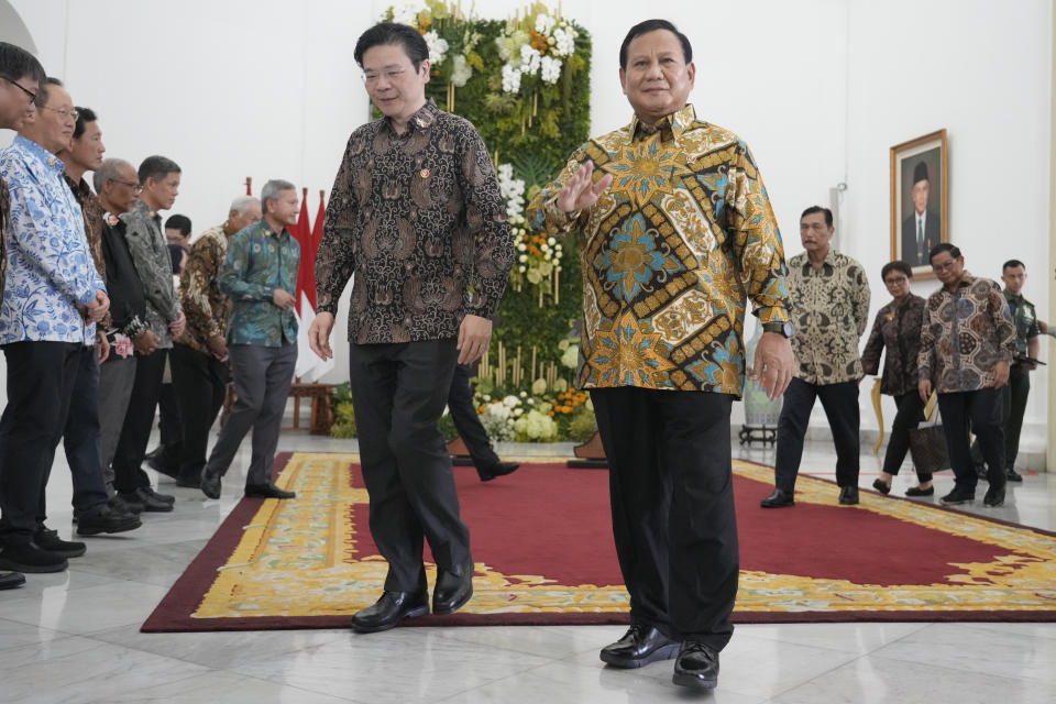 Indonesian Defense Minister and president-elect Prabowo Subianto, right, and Singapore's Deputy Prime Minister and Finance Minister Lawrence Wong walk during their meeting at Bogor Presidential Palace in Bogor, Indonesia, Monday, April 29, 2024. (AP Photo/Achmad Ibrahim)