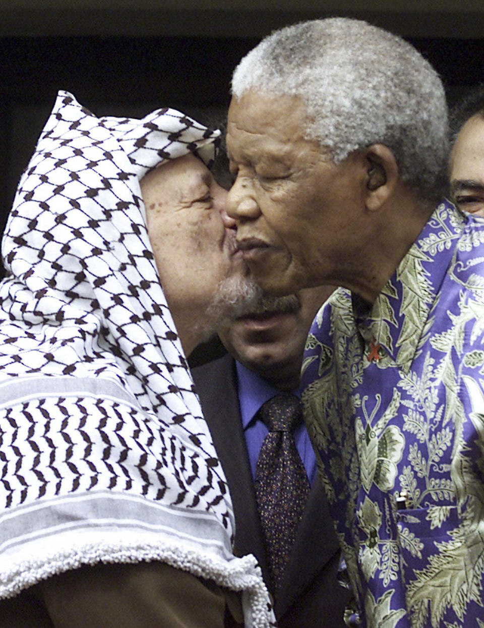 FILE — Late Palestinian leader Yasser Arafat, left, embraces the late former South Africa President Nelson Mandela, right, at a meeting in Johannesburg Thursday May 3, 2001. South Africa's long-held support for the Palestinian people can be traced back to the time of Mandela and Arafat with the two leaders believing that the struggle for freedom by Blacks in apartheid South Africa and Palestinians in Gaza and the West Bank were the same. (AP Photo/Denis Farrell, File)