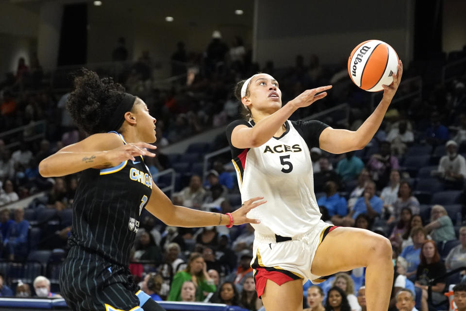 Las Vegas Aces' Dearica Hamby (5) scores past Chicago Sky's Candace Parker during the first half of the WNBA Commissioner's Cup basketball game Tuesday, July 26, 2022, in Chicago. (AP Photo/Charles Rex Arbogast)