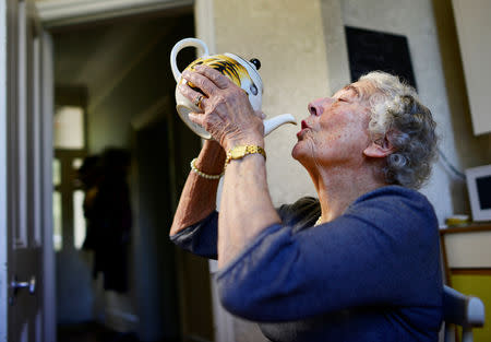 FILE PHOTO: British children's writer and illustrator Judith Kerr drinks from a tea pot as she recreates a scene from her bestselling picture book "The Tiger Who Came To Tea", at her home in west London, Britain September 30, 2015. REUTERS/Dylan Martinez/File Photo