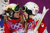 Second-placed Chloe Dufour-Lapointe (L) of Canada congratulates her sister, winner Justine Dufour-Lapointe (R), after the women's freestyle skiing moguls final competition at the 2014 Sochi Winter Olympic Games in Rosa Khutor, February 8, 2014. REUTERS/Mike Blake (RUSSIA - Tags: SPORT SKIING OLYMPICS)