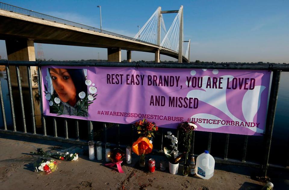 A memorial with flowers, candles and a large banner honors Brandy Ebanez of Kennewick. Her body was discovered along the Kennewick shoreline of the Columbia River.