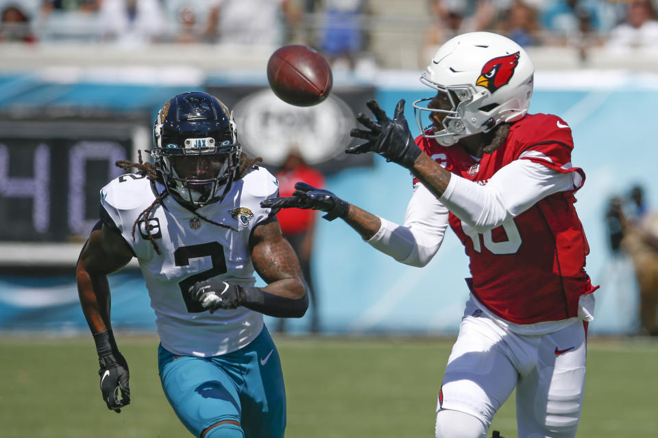 Arizona Cardinals wide receiver DeAndre Hopkins, right, makes a reception in front of Jacksonville Jaguars defensive back Rayshawn Jenkins (2) during the first half of an NFL football game, Sunday, Sept. 26, 2021, in Jacksonville, Fla. (AP Photo/Stephen B. Morton)