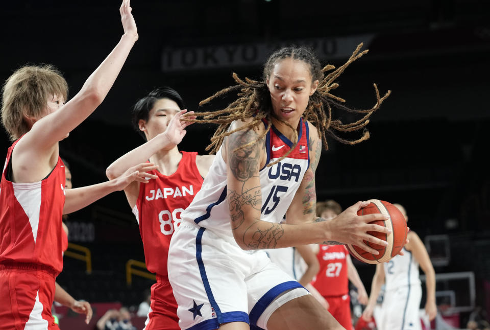 United States' Brittney Griner (15), right, drives past Japan's Maki Takada (8), left, and Himawari Akaho (88), center, during women's basketball preliminary round game at the 2020 Summer Olympics, Friday, July 30, 2021, in Saitama, Japan. (AP Photo/Eric Gay)