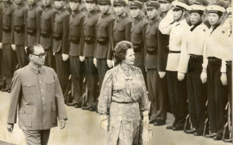 Margaret Thatcher, accomapanied by Zhao Ziyang, Chinese PM, as she inspects a Peoples Liberation Army guard of honour on her arrival in Beijing in 1982 - Credit: AP