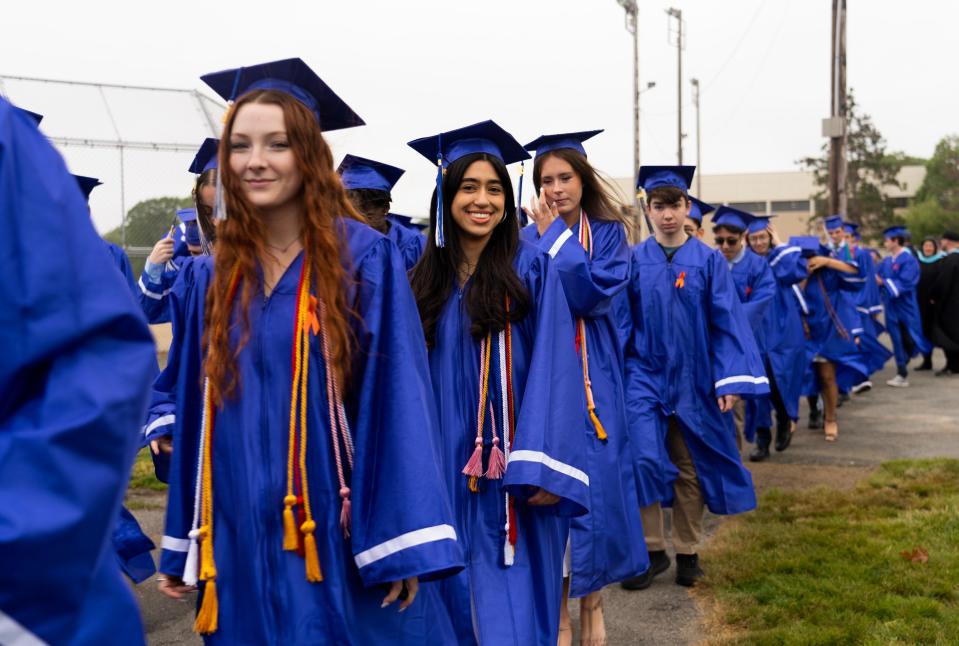 Graduating seniors from Braintree High School proceed onto the school field.