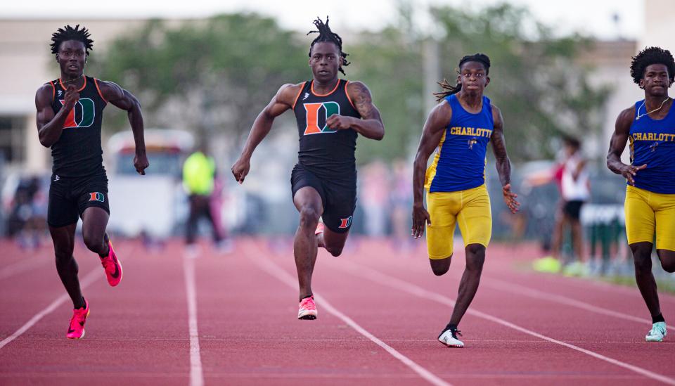 Tawaski Abrams, second from left, from Dunbar High School wins the 100 meters during the FHSAA 3A District 11 track & field meet at Dunbar High School on April 20, 2023. 