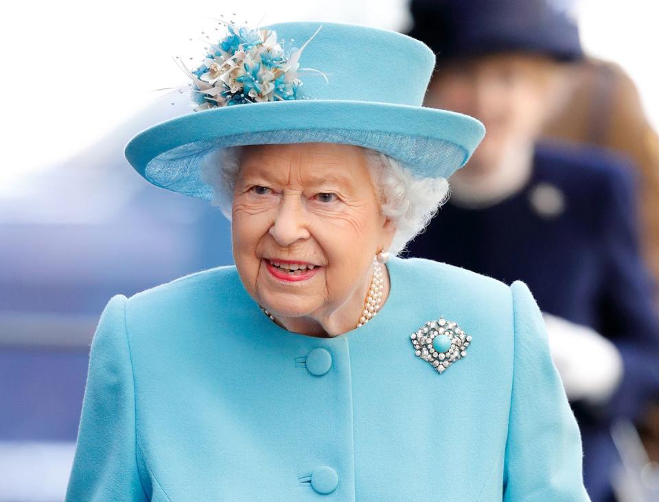 <p>Queen Elizabeth II—celebrating the centenary at Heathrow airport—again wears a cheerful shade of turquoise, accented by her oversized white diamond and turquoise brooch. </p>