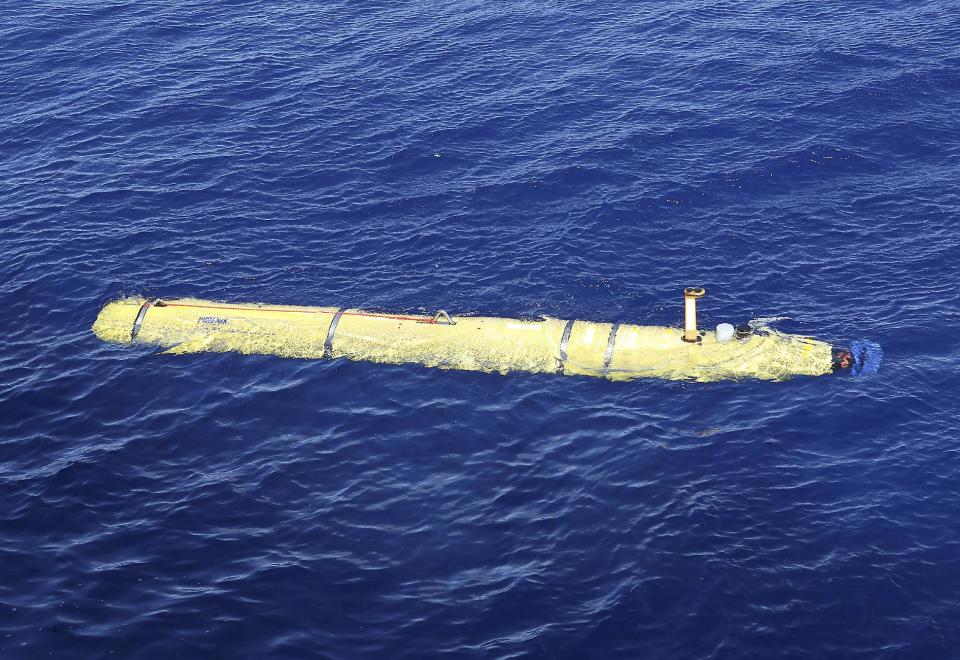 In this Thursday, April 17, 2014 photo provided by the Australian Defense Force, the Phoenix International Autonomous Underwater Vehicle (AUV) Artemis is launched from the Australian Defense Vessel Ocean Shield in to the southern Indian Ocean in the search of the missing Malaysia Airlines Flight 370. Up to 11 aircraft and 12 ships continue to scan the ocean surface for debris from the Boeing 777 that disappeared March 8 en route from Kuala Lumpur to Beijing with 239 people on board. (AP Photo/Australian Defense Force, Bradley Darvill) EDITORIAL USE ONLY