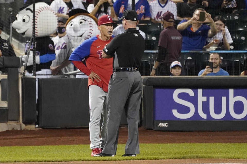 Philadelphia Phillies manager Joe Girardi, left, argues with umpire Carlos Torres during the seventh inning of a baseball game, Friday, Sept. 17, 2021, in New York. (AP Photo/Mary Altaffer)