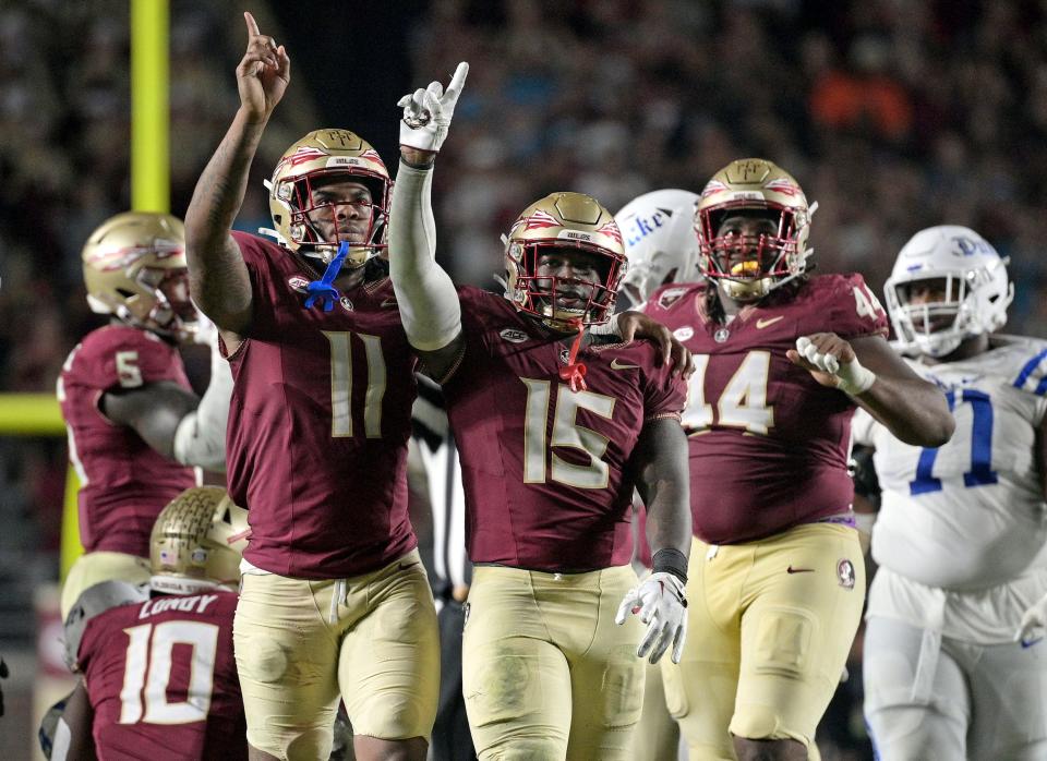 Florida State Seminoles linebacker Tatum Bethune and defensive lineman Patrick Payton celebrate a stop during the second half against the Duke Blue Devils at Doak S. Campbell Stadium.