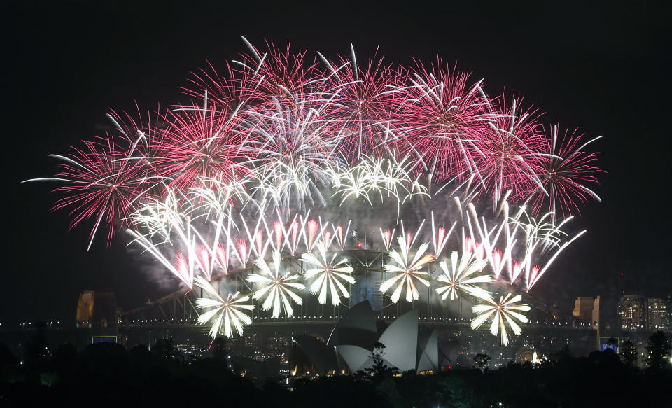 Fireworks explode over the Harbour Bridge and the Opera House during New Year's Eve celebrations in Sydney, Australia, Wednesday, Jan. 1, 2014. (AP Photo/Rob Griffith)