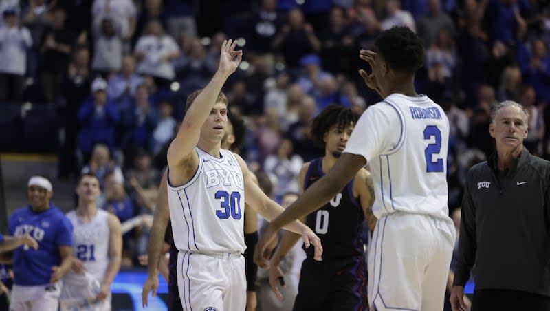BYU's Dallin Hall and Jaxson Robinson high-five as the Cougars play TCU on Saturday, March 2, 2024, at the Marriott Center in Provo, Utah. BYU won in comeback fashion, 87-75