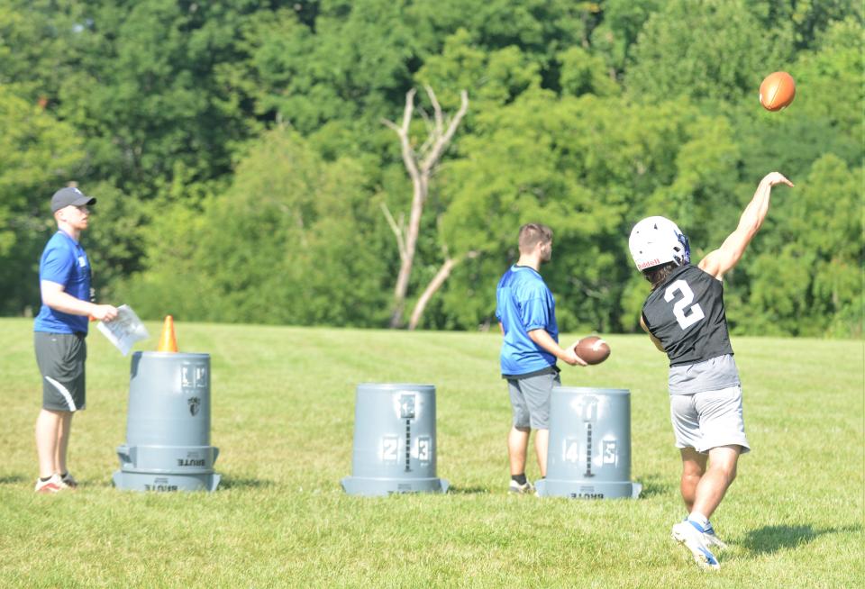 Zanesville's Drew Doyle launches a pass during an acclimation day on Wednesday. Doyle and senior Ma'ke Staunton are battling for the starting QB role for the Blue Devils.