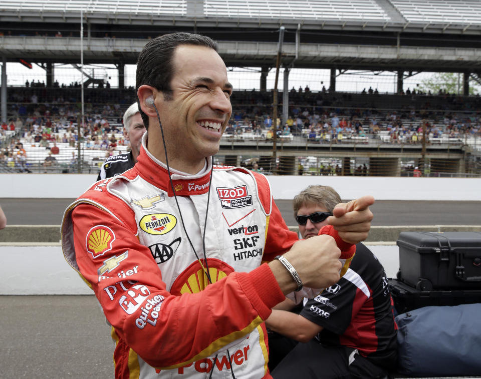 Helio Castroneves, of Brazil, jokes with members of his crew after his qualification run on the first day of qualifications for the Indianapolis 500 auto race at the Indianapolis Motor Speedway in Indianapolis, Saturday, May 18, 2013. (AP Photo/Tom Strattman)