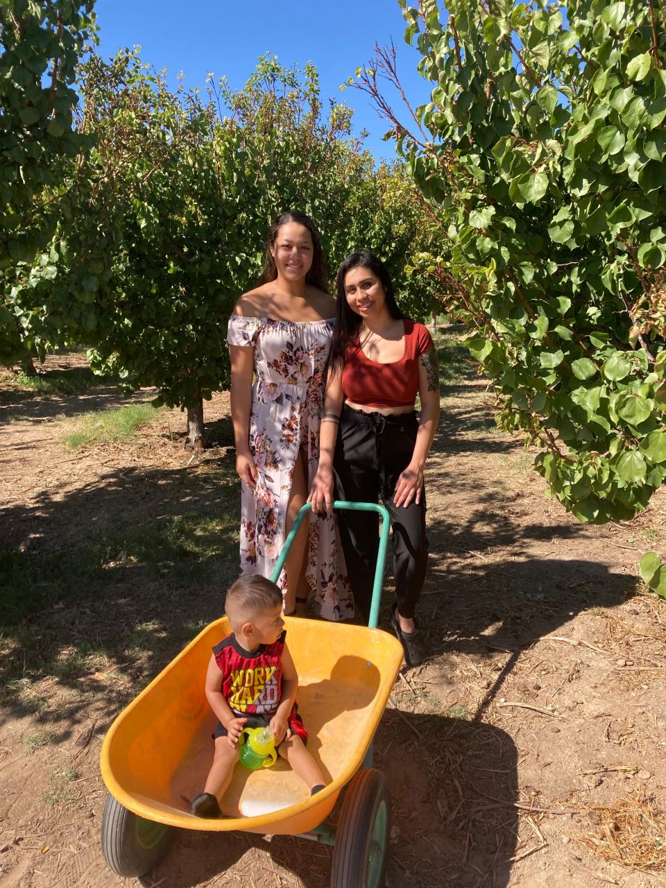Nina Perry, left, and friend Diana Bobadilla and her son, Benicio, at Gilcrease Orchard on Oct. 10, 2021.