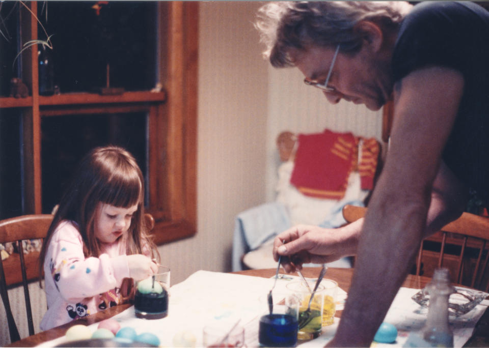a dad painting at the kitchen table with his young daughter