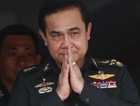 Thailand's newly appointed Prime Minister Prayuth Chan-ocha gestures in a traditional greeting during his visit to the 2nd Infantry Battalion, 21st Infantry Regiment, Queen's Guard in Chonburi province, on the outskirts of Bangkok August 21, 2014. REUTERS/Chaiwat Subprasom