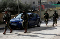 Israeli forces walk during a raid in Ramallah in the Israeli-occupied West Bank December 13, 2018. REUTERS/Mohamad Torokman