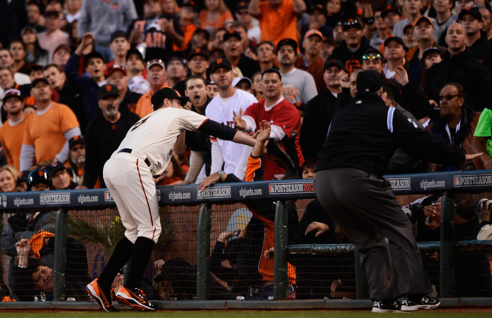 Brandon Belt #9 of the San Francisco Giants catches a foul pop-up by Zack Cozart #2 of the Cincinnati Reds during Game One of the National League Division Series at AT&T Park on October 6, 2012 in San Francisco, California. (Photo by Thearon W. Henderson/Getty Images)