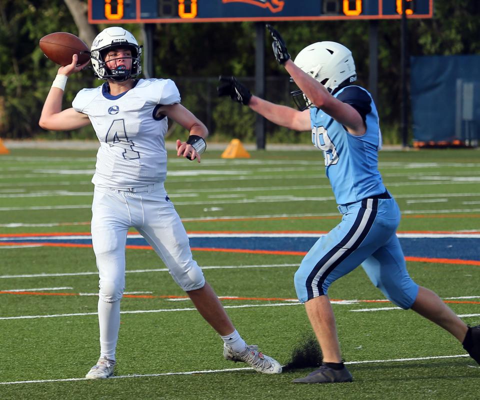 Oasis High quarterback Parker Smith looks to pass as he is pressured by Out-of-Door's Bennett Crisci.