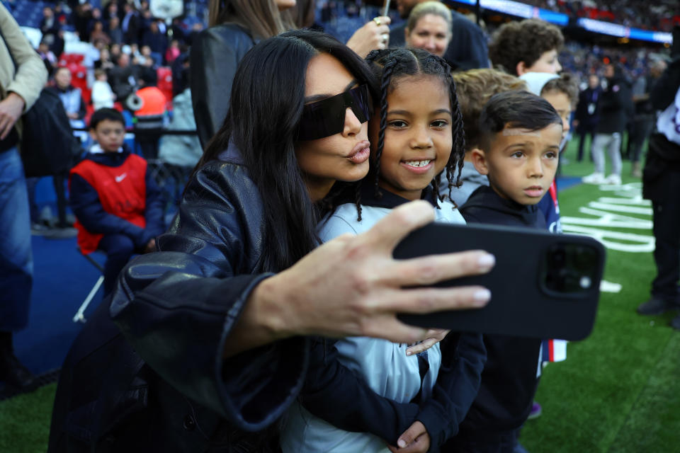 PARIS, FRANCE - MARCH 19: Saint West and Kim Kardashian attend the Ligue 1 match between Paris Saint-Germain and Stade Rennes at Parc des Princes on March 19, 2023 in Paris, France. (Photo by Aurelien Meunier - PSG/PSG via Getty Images)