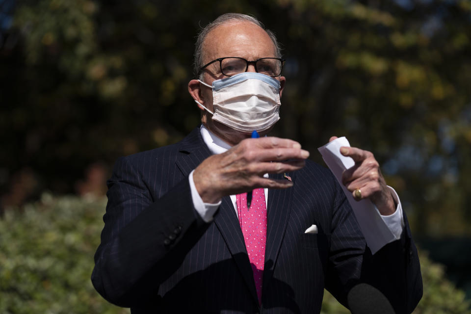 White House chief economic adviser Larry Kudlow talks with reporters outside the White House about coronavirus relief package negotiations, Friday, Oct. 9, 2020, in Washington. (AP Photo/Evan Vucci)