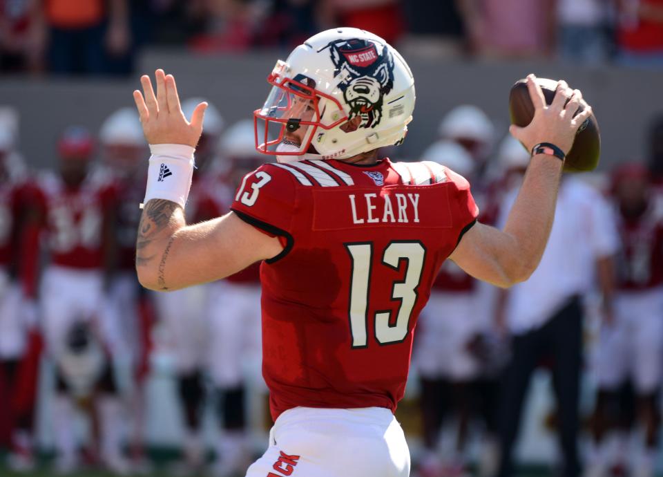 Sep 25, 2021; Raleigh, North Carolina, USA; North Carolina State Wolfpack quarterback Devin Leary (13) throws a pass during the first half against the Clemson Tigers at Carter-Finley Stadium. Mandatory Credit: Rob Kinnan-USA TODAY Sports