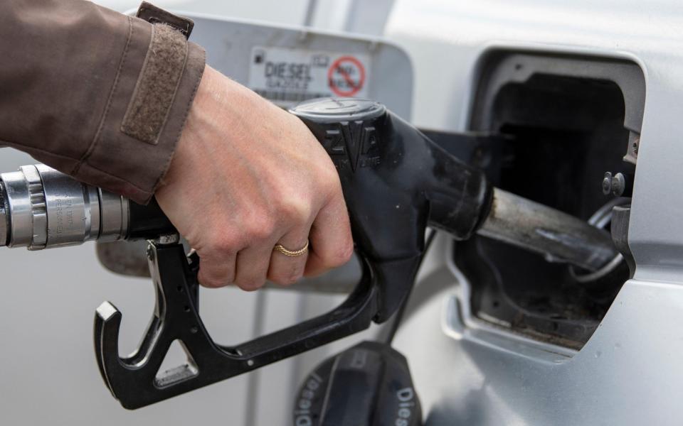 Woman putting diesel fuel into her car at a fuel station. North Yorkshire, UK. - Wayne HUTCHINSON / Alamy Stock Photo