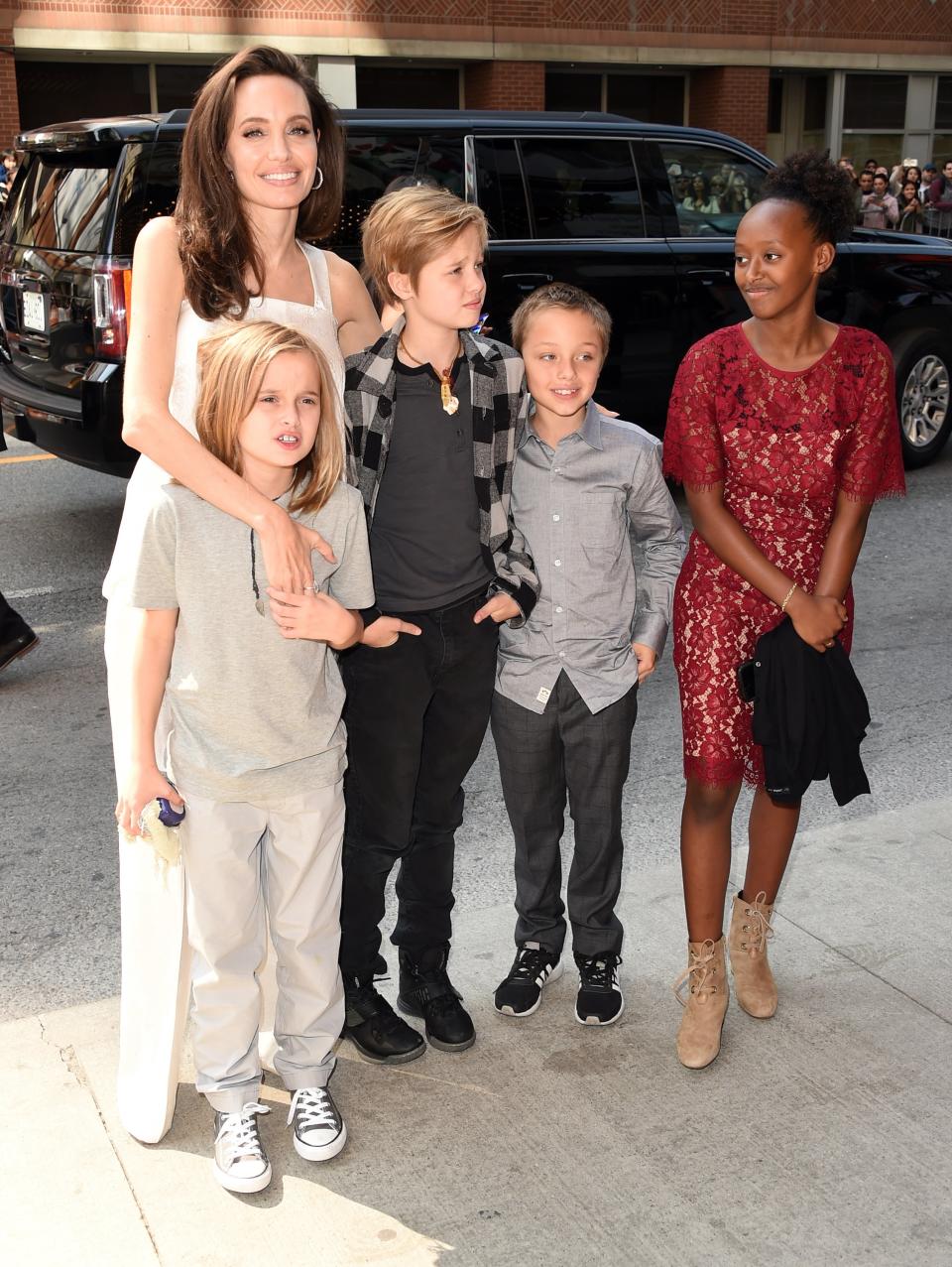 Jolie shared a squeeze with her three youngest before facing photographers.