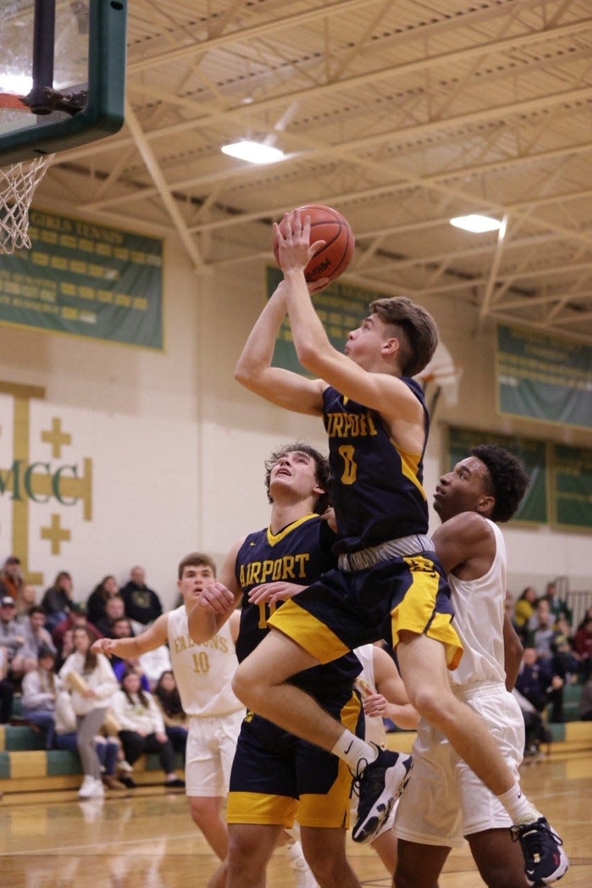 Colin Nowak of Airport shoot over SMCC's Buddy Snodgrass Tuesday night.