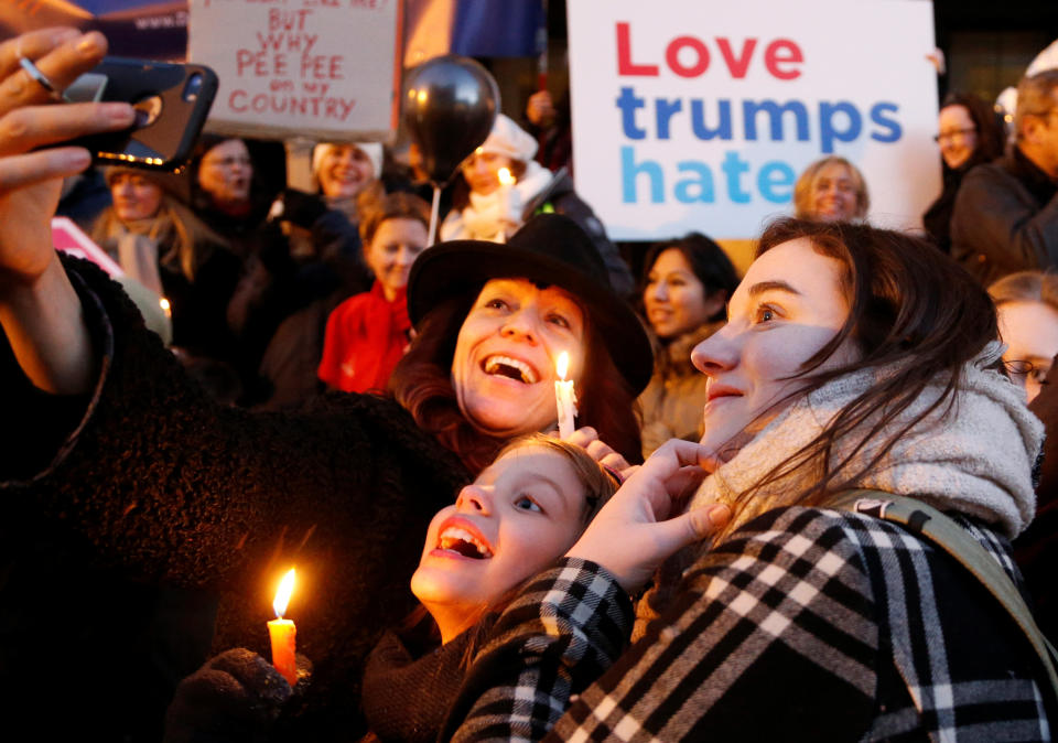 Women take a selfie as they take part in the women's rights event "Lights for Rights", a protest against the inauguration of Donald Trump as new U.S. president, in front of the Theatre Royal de la Monnaie in Brussels, Belgium, January 20, 2017.&nbsp;