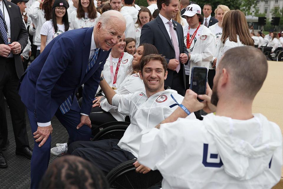 U.S. President Joe Biden takes pictures with members of Team USA on the South Lawn at the White House on May 04, 2022 in Washington, DC. President Biden hosted the team to celebrate their victories in the Tokyo 2020 Summer Olympic and Paralympic Games and Beijing 2022 Winter Olympic and Paralympic Games.