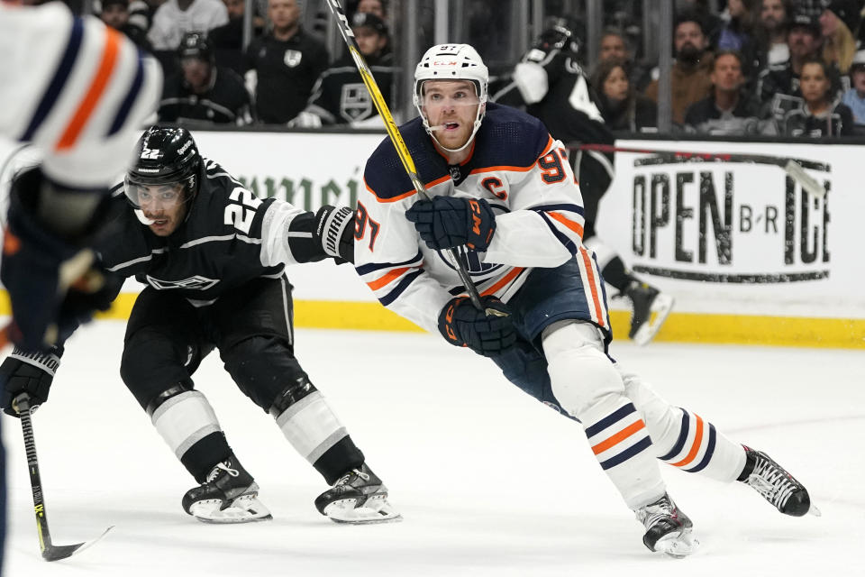 Edmonton Oilers center Connor McDavid, right, skates while being followed by Los Angeles Kings center Andreas Athanasiou during the second period in Game 6 of an NHL hockey Stanley Cup first-round playoff series Thursday, May 12, 2022, in Los Angeles. (AP Photo/Mark J. Terrill)