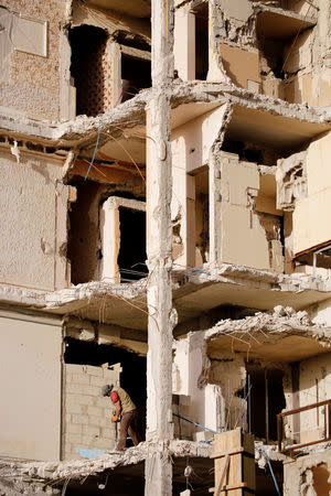 A worker works at a construction site in Ein Terma, a district of eastern Ghouta, Syria February 26, 2019. REUTERS/Omar Sanadiki