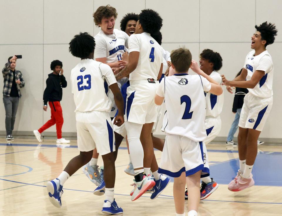 Holbrook's Owen Burke, left, celebrates with teammates after scoring his 1,000th career point during a game versus South Shore Christian Academy on Friday, Jan. 13, 2023.