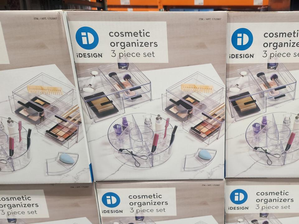 A box depicting clear plastic cosmetics organizers and makeup  with "iDesign cosmetic organizers" label