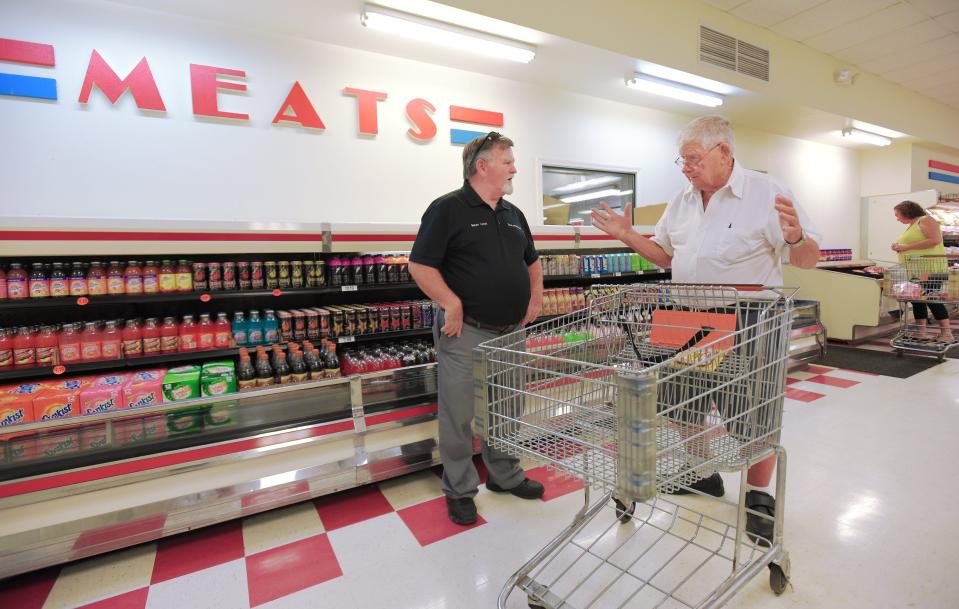 Baldwin Mayor Sean Lynch talks with a shopper on Sept. 20, 2019 when the Baldwin Market opened as a town-owned and town-run grocery store. After private grocers came and went from Baldwin, the town decided to open the store so residents wouldn't have to travel miles for grocery shopping.